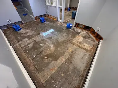Air movers drying a Framingham room after the wet flooring was removed