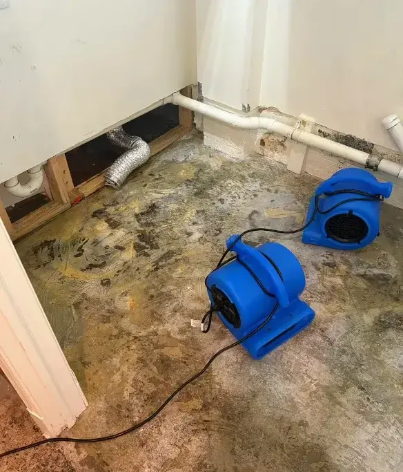 Air movers drying a subfloor after a pipe leak in a Framingham home